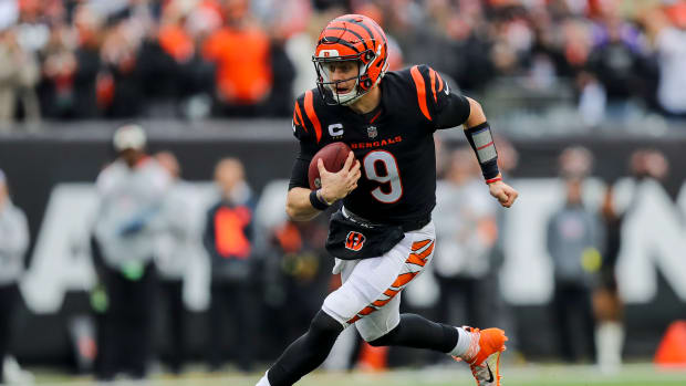 Bengals quarterback Joe Burrow runs with the ball.